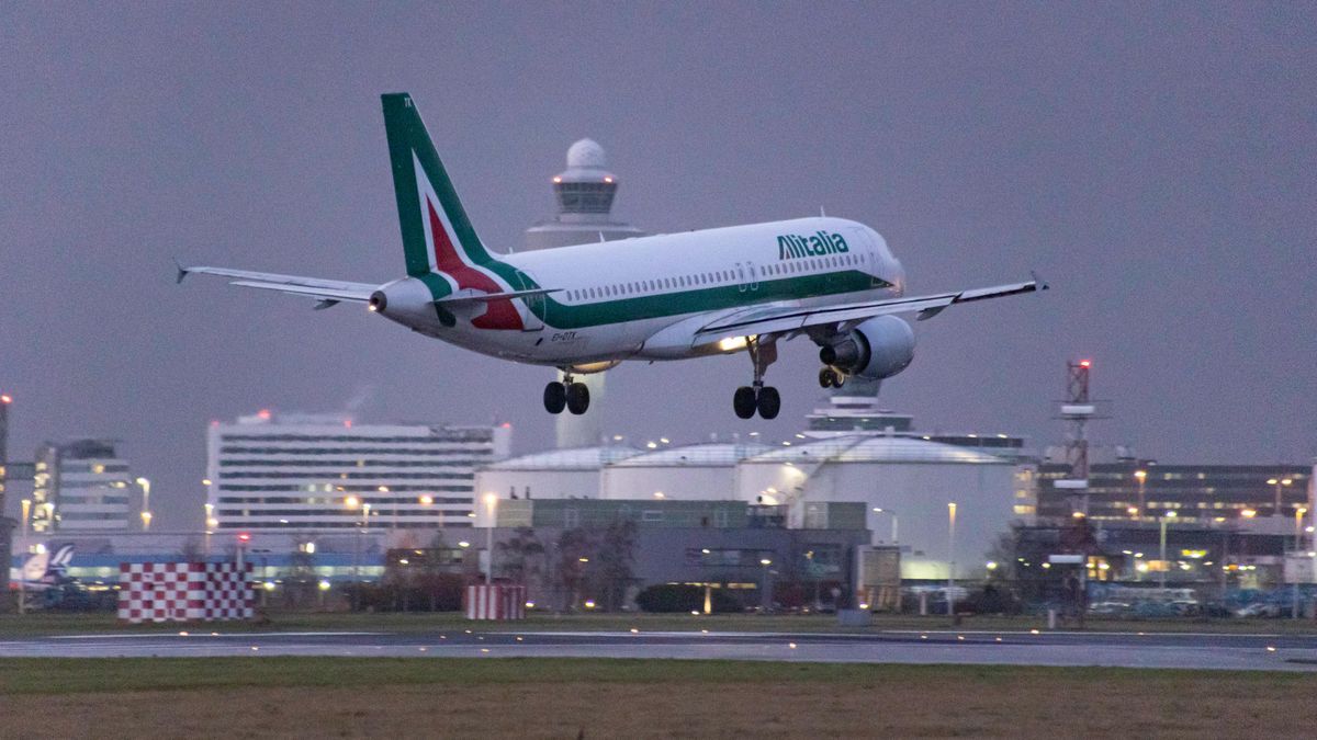 ITA Airways Airbus A320 aircraft as seen on final approach flying and landing at Amsterdam Schiphol Airport AMS EHAM with the control tower and the airport terminal in the background. The arriving airplane has the registration EI-DTK and the older paint livery of Alitalia. ITA Airways -Italia Trasporto Aereo is the state owned flag carrier of Italy as a successor of Alitalia that commenced operations on 15 October 2021 fully owned by the Government of Italy via their Ministry of Economy and Finance. ITA is a member of SkyTeam aviation alliance group. The aviation industry and passenger traffic is phasing a difficult period with the Covid-19 coronavirus pandemic having a negative impact on the travel business industry with fears of the worsening situation due to the new Omega variant mutation. Amsterdam, the Netherlands on January 5, 2022 (Photo by Nicolas Economou/NurPhoto via Getty Images)