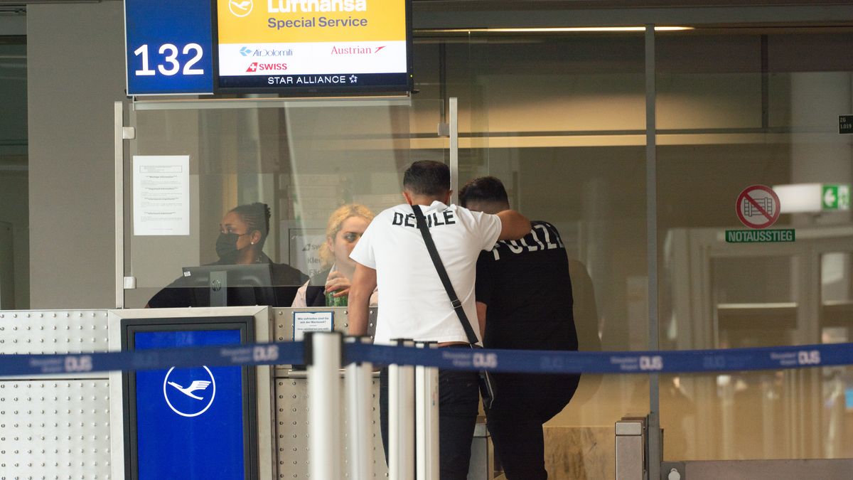 two travellers are seen in front of Lufthansa check in counter at Duesseldorf airport in Duesseldorf, Germany on July 27, 2022 as Verdi union organizes Lufthansa ground staffs go on strike and demand for collective bargainning (Photo by Ying Tang/NurPhoto via Getty Images)