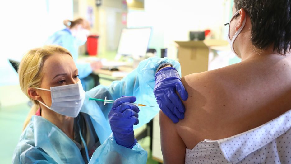 A health worker injects a shot of Covid-19 vaccine on the first day of the opening of the new Covid-19 Vaccination point at Tauron Arena Krakow. Krakow, Poland on May 7, 2021. Up to 2,000 people can be vaccinated daily with Moderna or AstraZeneca vaccines at the 3rd massive vaccination point in Krakow and 18th in the entire Lesser Poland Voivodeship. (Photo by Beata Zawrzel/NurPhoto via Getty Images)