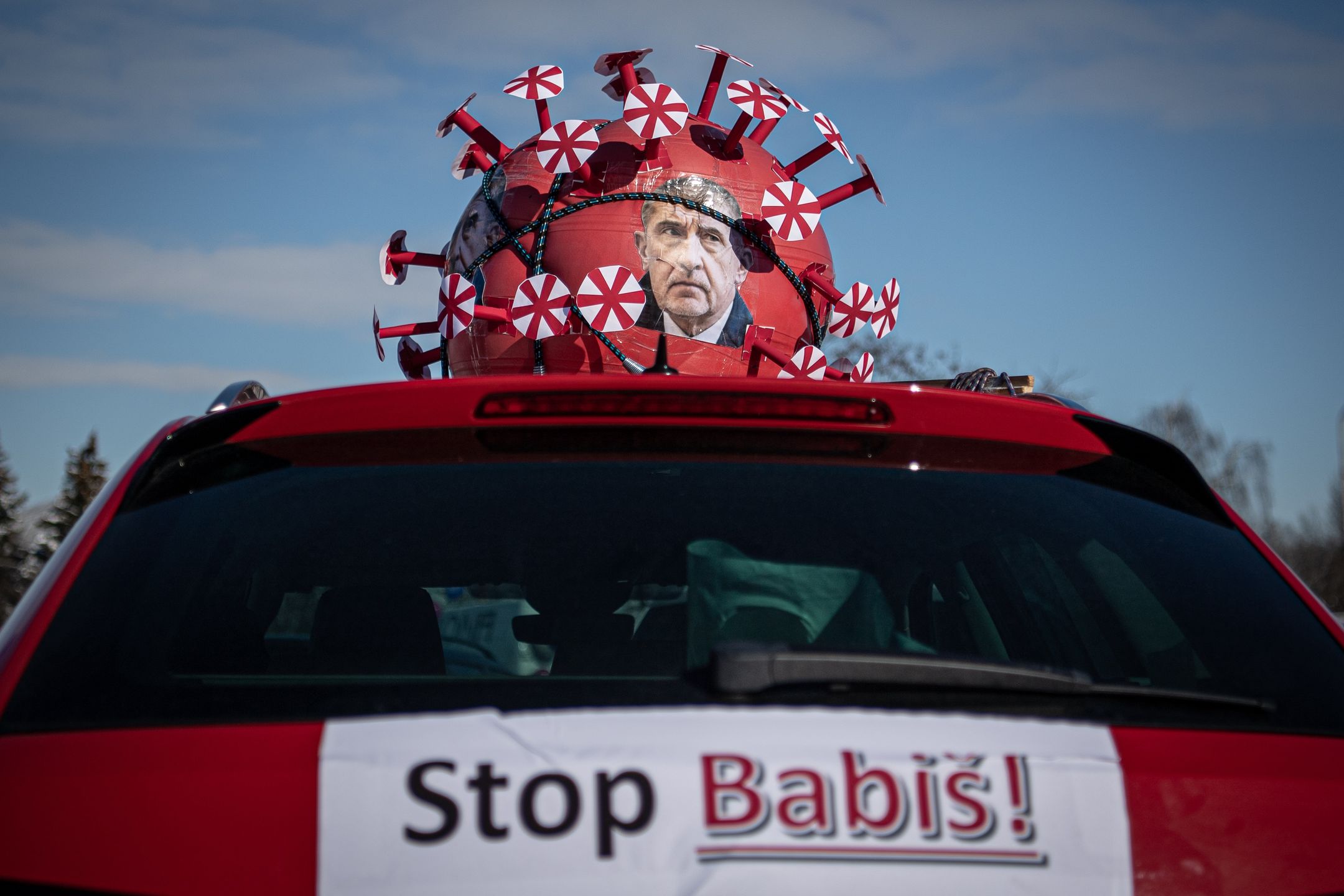 PRAGUE, CZECH REPUBLIC - FEBRUARY 13: A shape of the coronavirus with portrait of Czech Prime Minister Andrej Babis on car as people gathered in cars for carnival protest parade against government and Czech Prime Minister Andrej Babis in Prague, Czech Republic on February 13, 2021., Czech Republic on February 13, 2021. About 300 cars decorated with signs took part in allegorical car protest. The event was organized by the Million Moments for Democracy Association, which wanted to draw attention to various cases of the current government. (Photo by Lukas Kabon/Anadolu Agency via Getty Images)