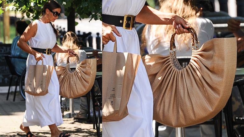 Kinga Rusin z designerską torbą wychodzi z lokalu