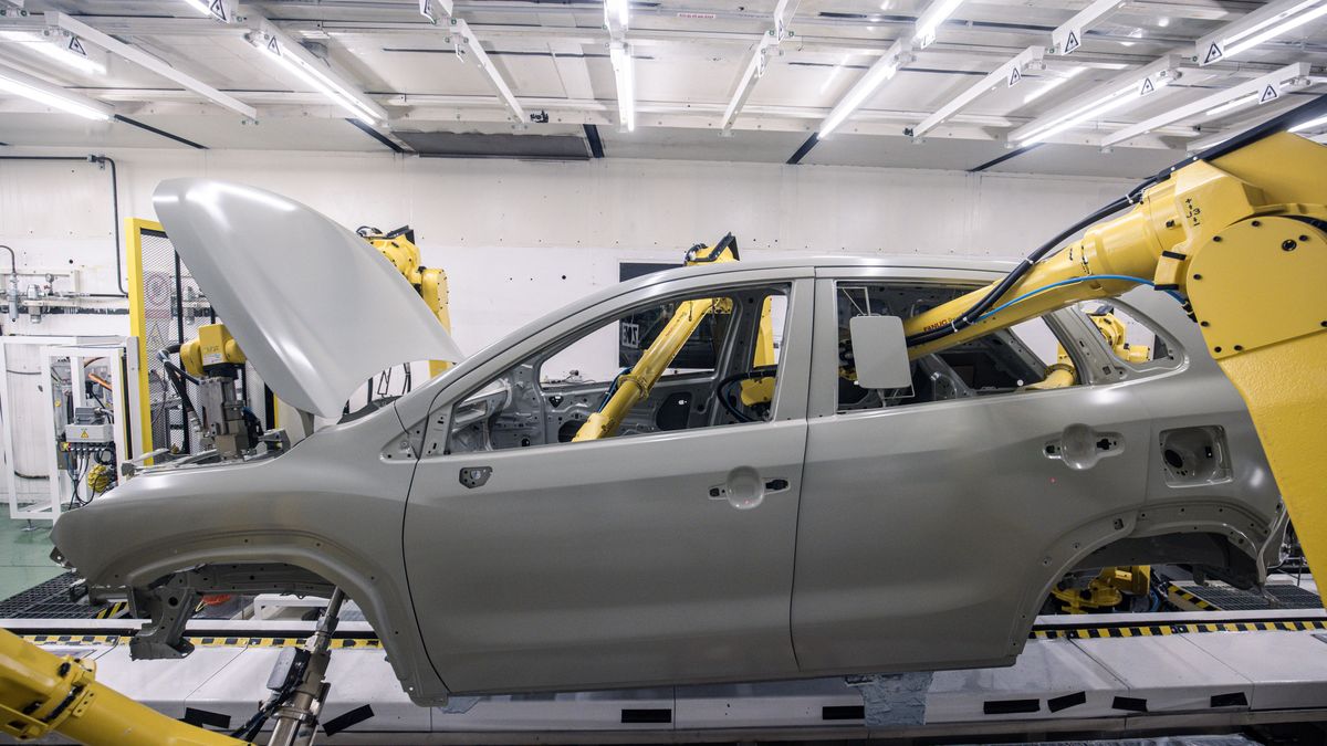Robotic arms spray the body shell of an automobile in the paint shop inside the Suzuki Motor Corp. plant in Esztergom, Hungary, on Wednesday, Oct. 19, 2022. European automotive stocks gained a boost from figures showing that new car sales in the region rose for a second month in September as supply-chain issues eased. Photographer: Akos Stiller/Bloomberg via Getty Images