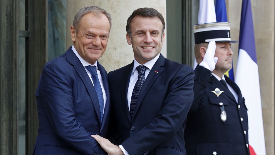 PARIS, FRANCE - FEBRUARY 12: French President Emmanuel Macron (R) welcomes Poland's Prime Minister Donald Tusk prior to a working lunch at Elysee Presidential Palace on February 12, 2024 in Paris, France. The Polish Prime Minister Donald Tusk assumed office in December after his alliance displaced the conservative Law and Justice Party in Poland's general elections. (Photo by Chesnot/Getty Images)