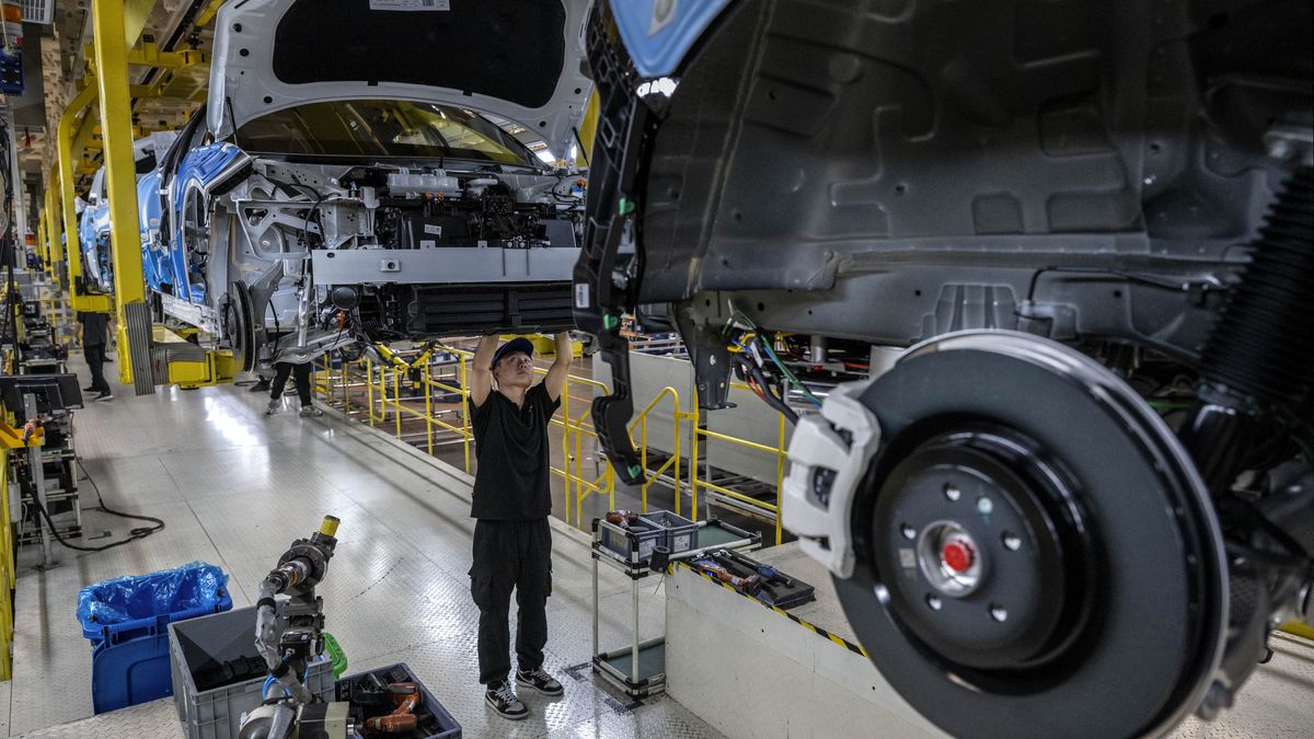 NINGBO, CHINA - MAY 29: A worker assembles a car on the production line for electric vehicle maker Zeekr at its factory on May 29, 2025 in Ningbo, China. China's automakers account for nearly two-thirds of global sales of electric vehicles and exports more vehicles overseas than any other country. Zeekr, a pure-electric brand aimed at the luxury market, has seen sales growth in the highly competitive Chinese market and is furthering its expansion into Asia, the Middle East, Latin America, and parts of Europe. The company's plans to enter the US market has faced hurdles due to tariffs on China made electric vehicles. In 2024, Zeekr delivered more than 220,000 vehicles, according to the company. Zeekr is among several Chinese EV makers building vehicles in automated factories using robotics powered by artificial intelligence alongside human workers. Zeekr is owned by Geely Holdings, which also has ownership stake in a number of foreign brands including Volvo, Lotus, and Polestar. (Photo by Kevin Frayer/Getty Images)