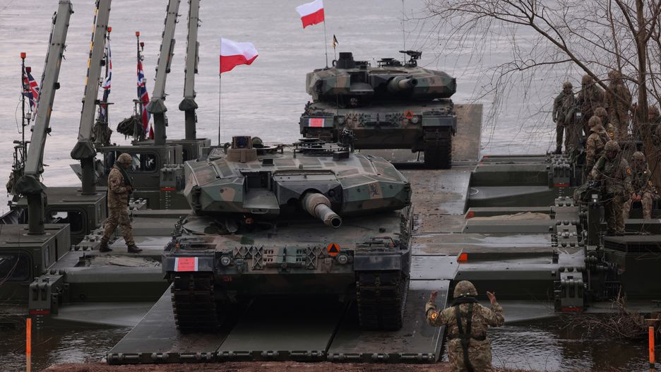 GNIEW, POLAND - MARCH 04: Leopard 2PL main battle tanks of the Polish armed forces descend from M3 amphibious rigs of the German/British Amphibious Engineer Battalion 130 after crossing the Vistula River during the NATO Dragon 24 military exercise on March 04, 2024 near Gniew, Poland. Dragon 24 is involving 20,000 troops from 10 different nations and is part of Steadfast Defender 2024, an ongoing set of NATO military manoeuvres across Europe that is involving 90,000 troops. (Photo by Sean Gallup/Getty Images)