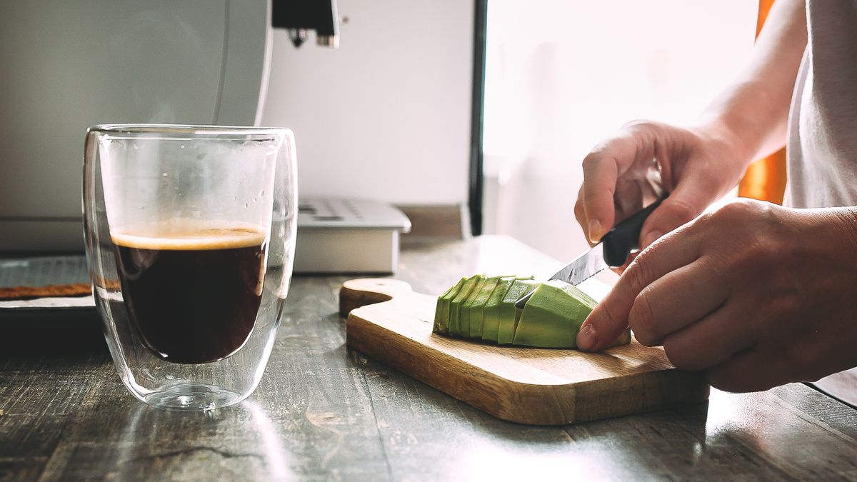 Female hand cutting avocado on a wooden cutting board for toasts. Glass mug with hot coffeeFemale hand cutting avocado on a wooden cutting board for toasts. Glass mug with hot coffeeAlexandr Kolesnikovkid, boy
