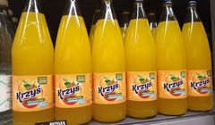 Napój Krzyś pomarańczowy w szklanym opakowaniu zwrotnym dostępny w Carrefour