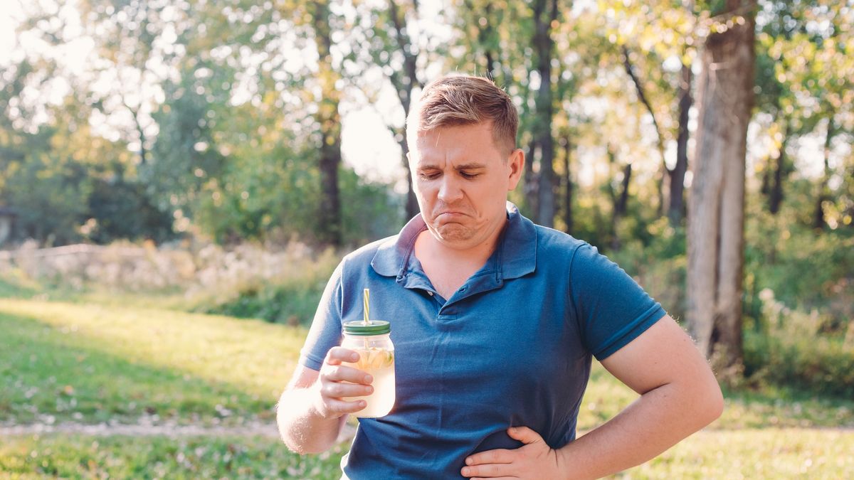 Man with stomach pain. Unhappy man outdoors, immersed in nature, drinks a glass of homemade lemonade or a mojito.
Man with stomach pain. Unhappy man outdoors drinks a glass of homemade lemonade or a mojito.
Mariia Skovpen