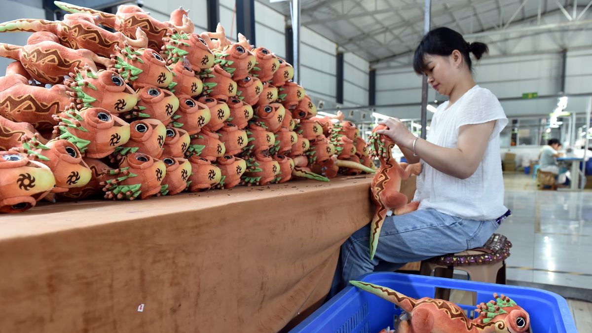 CHONGQING, CHINA - AUGUST 14: An employee sews plush toys "Guaimei", Yunyang's new dinosaur intellectual property character, at a factory on August 14, 2024 in Yunyang county, Chongqing of China. (Photo by Rao Guojun/VCG via Getty Images)