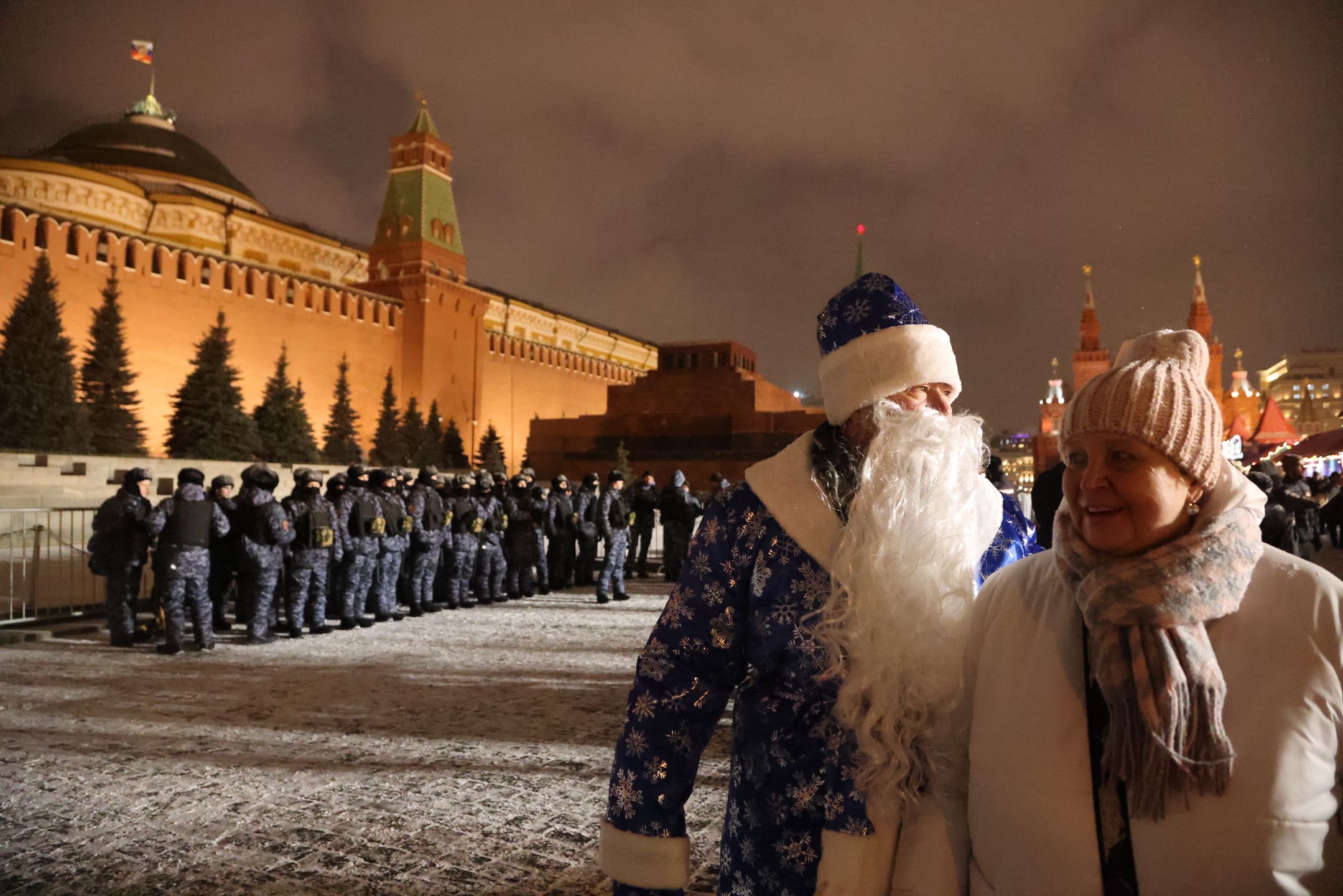 Russians Celebrate New Year's Eve 2023MOSCOW, RUSSIA - DECEMBER 31 (RUSSIA OUT) A man dressed as Father Frost walks past Russian National Guard Service's OMON special unit officers on Red Square near the Kremlin on December 31, 2023 in Moscow, Russia. Hundreds people gathered in Central Moscow to celebrate New Year's Eve, while the authorities banned holiday fireworks in most cities of the country, including the capital. (Photo by Contributor/Getty Images)Contributor
