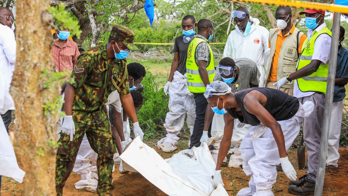KILIFI, KENYA - APRIL 23: Officials carry a dead body of a person who died in Kenya's starvation cult near the Good News International Church in Malindi town of Kilifi, Kenya on April 23, 2023. The death toll hit 90 in Kenya's starvation cult. Interior Minister Kithure Kindiki visited the site where bodies are being exhumed. Kindiki said he wants Pastor Mackenzie Nthenge charged with genocide. (Photo by Stringer/Anadolu Agency via Getty Images)