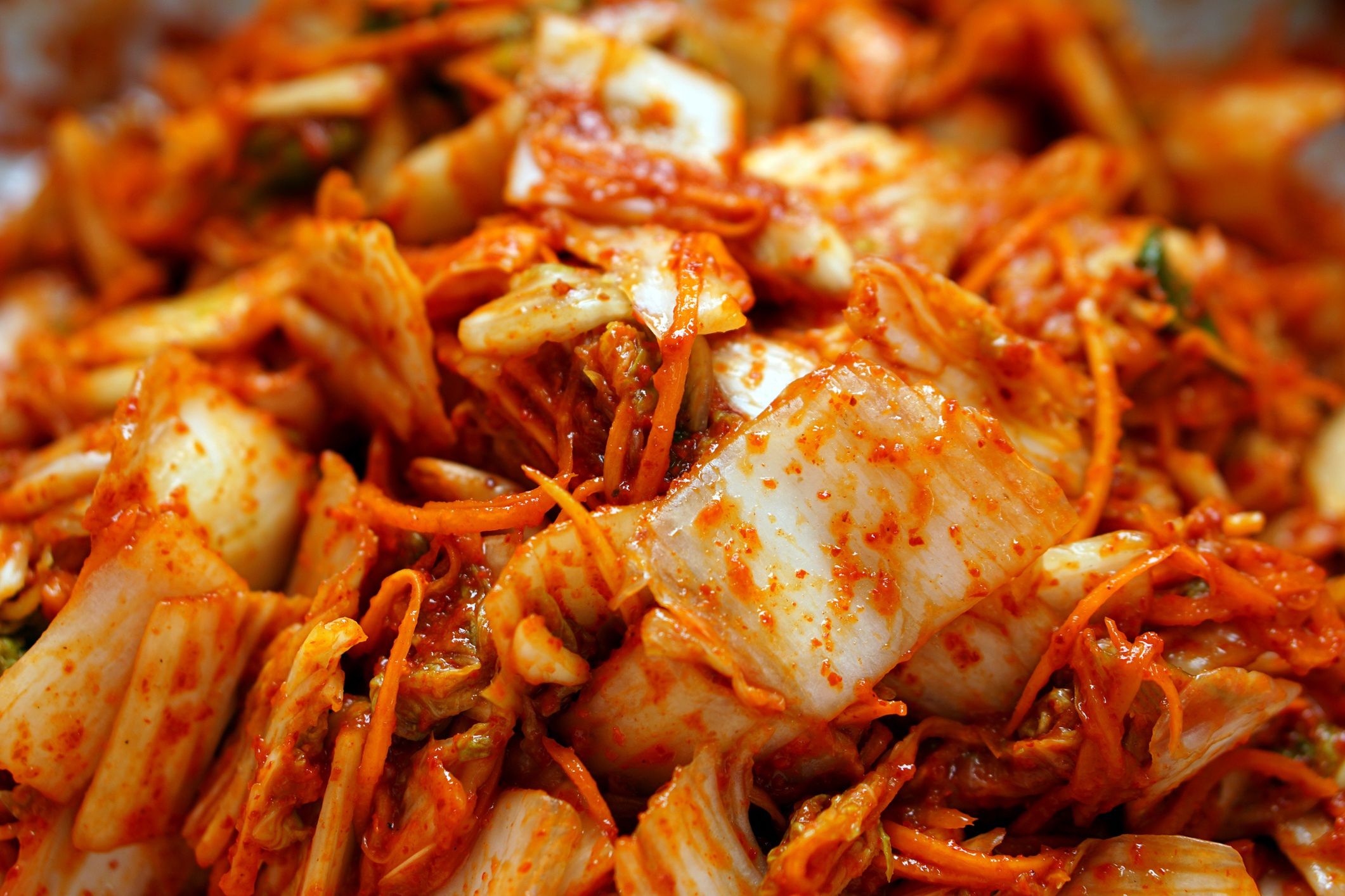 Close up photo of kimchi. Homemade Korean fermented cabbage
Kimchi, is a traditional Korean side dish of salted and fermented vegetables with a sour and spicy taste. One of the most common types of kimchi is cabbage kimchi. The striking red color, unique taste and smell make kimchi one of the most loved foods.
angga