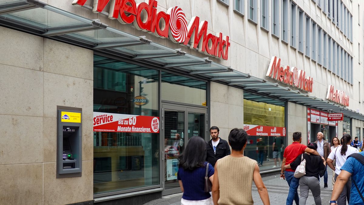 People walk past the Media Markt electronics retail store on a shopping street in Cologne, North Rhine-Westphalia, Germany, on August 3, 2025. (Photo by Michael Nguyen/NurPhoto via Getty Images)