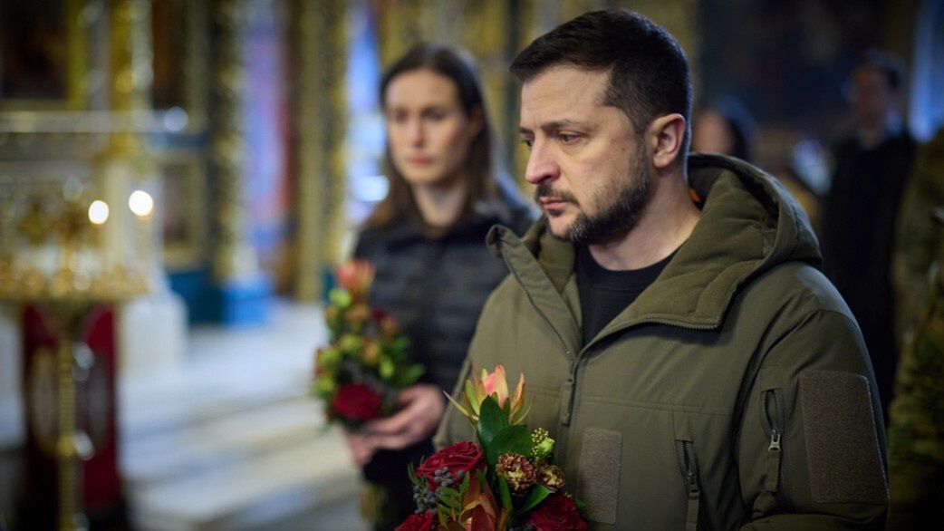 KYIV, UKRAINE - MARCH 10: (----EDITORIAL USE ONLY â MANDATORY CREDIT - 'UKRAINIAN PRESIDENCY / HANDOUT' - NO MARKETING NO ADVERTISING CAMPAIGNS - DISTRIBUTED AS A SERVICE TO CLIENTS----) Ukrainian President Volodymyr Zelenskyy (front) and Finnish Prime Minister Sanna Marin (rear) attend the funeral of Ukrainian soldier Dmytro Kotsiubaylo, who was awarded the Hero of Ukraine award by the President of Ukraine Volodymyr Zelensky in 2021, in Kyiv, Ukraine on March 10, 2023. Kotsiubaylo was killed in battle in Bakhmut on March 7. (Photo by Ukrainian Presidency / Handout/Anadolu Agency via Getty Images)