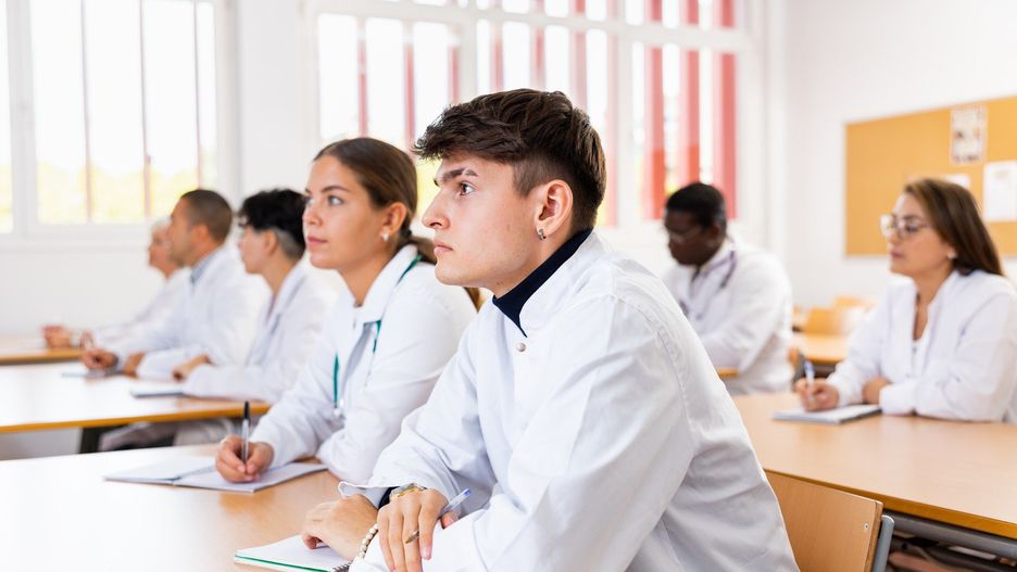 Young man medical student attending lecture in university