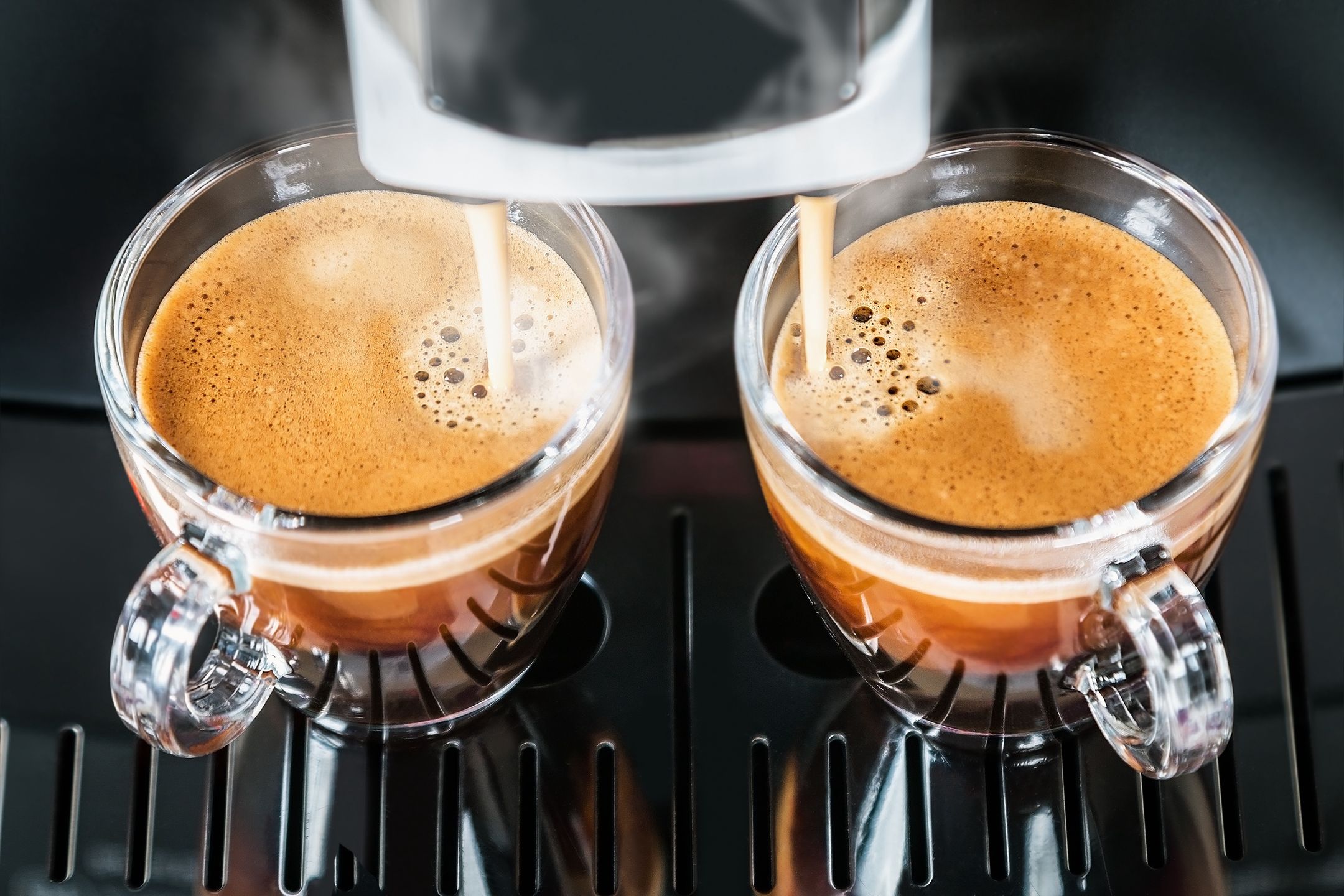freshly brewed coffee is poured from the coffee machine into glass cupsautomatic, coffee-shop, two, kitchen, glass, house, cafeteria, mug, pouring, dispenser, coffee, machine, cafe, bar, drink, brown, restaurant, hot, espresso, cup, professional, fresh, closeup, maker, beverage, caffeine, barista, black, service, modern, breakfast, morning, make, prepare, food