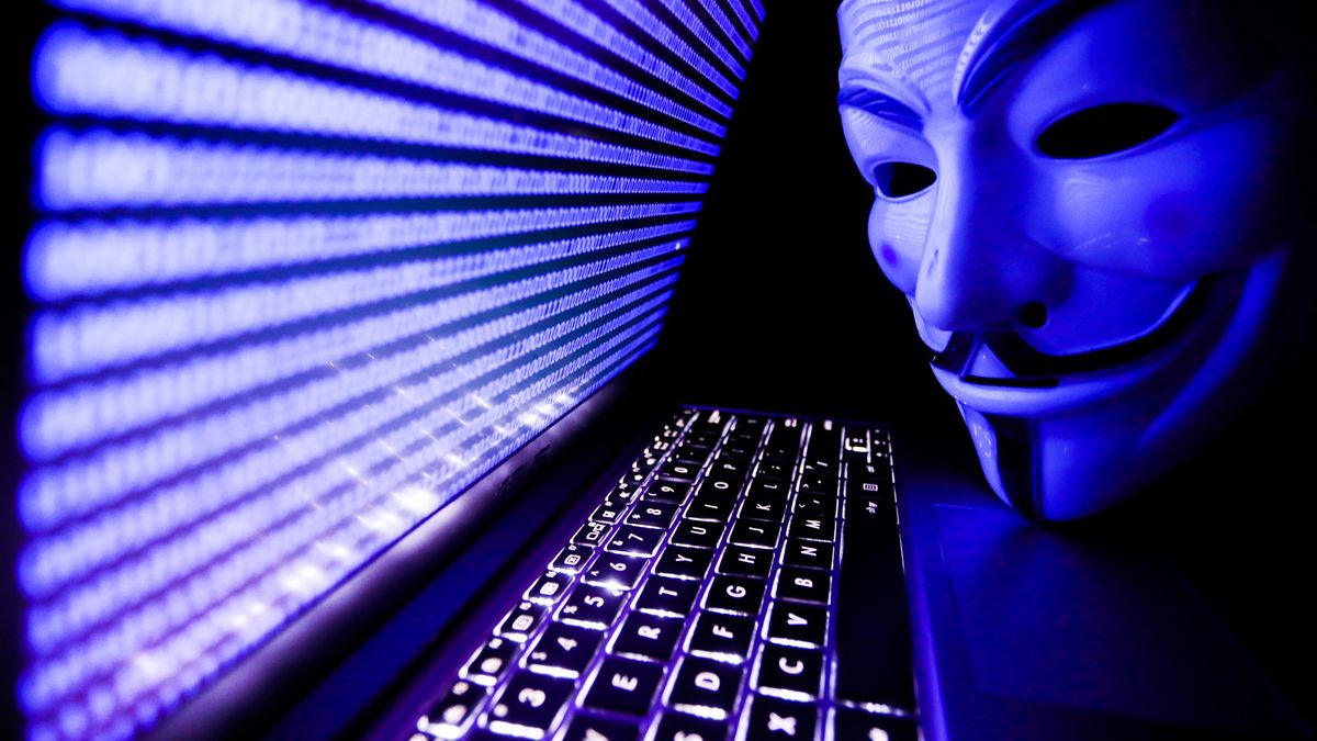 Binary code displayed on a laptop screen and Guy Fawkes mask are seen in this illustration photo taken in Krakow, Poland on March 1, 2022. Global hacker group Anonymous declared 'cyber war' against Russia. (Photo by Jakub Porzycki/NurPhoto via Getty Images)