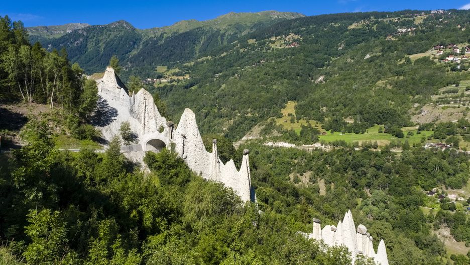 EUSEIGNE, VALAIS, SWITZERLAND - 2022/07/09: View of Euseigne pyramids, chimney rock formations named Pyramides d'Euseigne, with the road leading through a small tunnel. (Photo by Frank Bienewald/LightRocket via Getty Images)