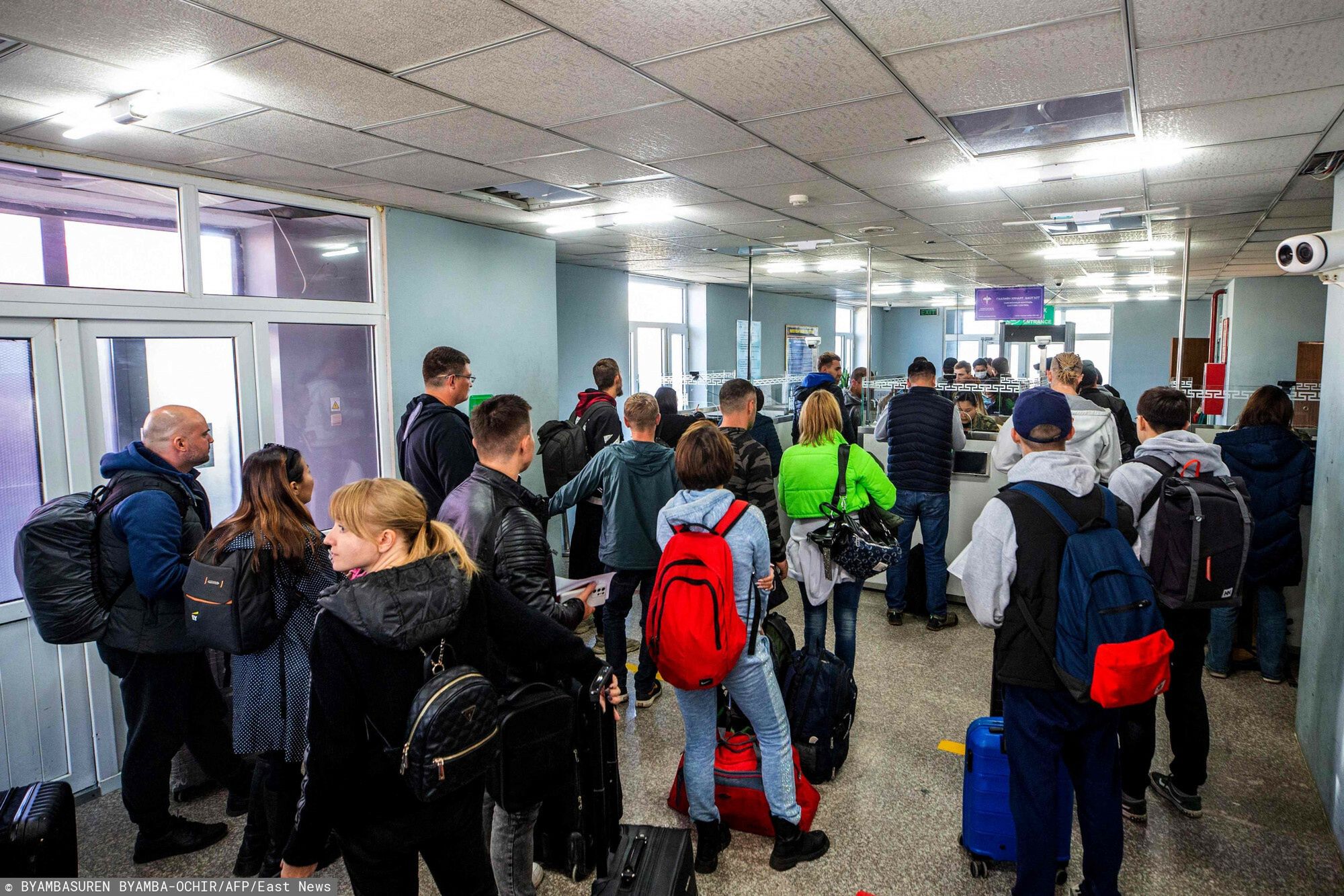 TemporaryPeople arriving from Russia wait at the Mongolian border checkpoint of Altanbulag on September 25, 2022, after the Kremlin announced a partial mobilisation for the war in Ukraine. - The borders with Kazakhstan and Mongolia have been overwhelmed an influx of Russian nationals, with reports of people sometimes waiting several hours before being able to cross. (Photo by BYAMBASUREN BYAMBA-OCHIR / AFP)BYAMBASUREN BYAMBA-OCHIR