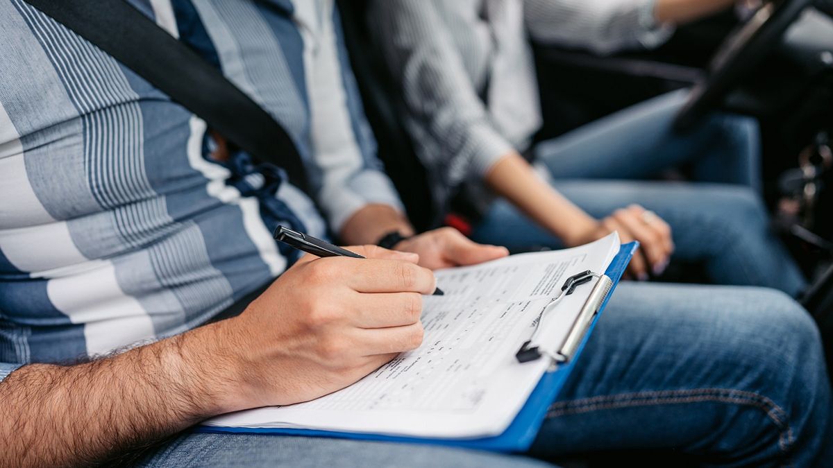 Young Driving Instructor Grading His Female Student Using A Checklist
Young driving instructor grading his female student on a driving test, using a checklist. Close-up.
urbazon