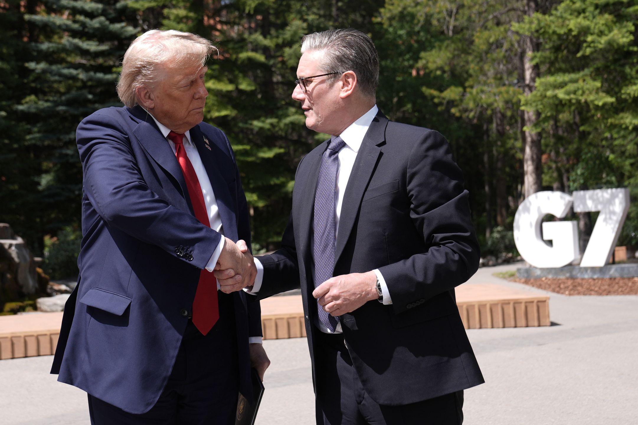 KANANASKIS, CANADA - JUNE 16: US President Donald Trump (left) shakes hands with Prime Minister Sir Keir Starmer while speaking to the media at the G7 Leaders' Summit on June 16, 2025 in Kananaskis, Canada. Keir Starmer is attending his first G7 leaders' summit, where issues on the table for discussion are the escalating conflict in the Middle East, as well as the failure to bring peace to Ukraine. (Photo by Stefan Rousseau-Pool/Getty Images)