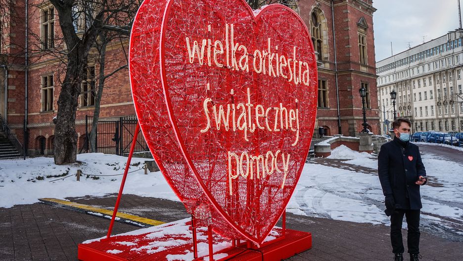 People attending the 29th Grand Finale of Great Orchestra of Christmas Charity taking a picture in front of giant red heaart - the WOSP symbol are seen in Gdansk, Poland on 31 January 2021 . The yearly fundraiser Great Orchestra of Christmas Charity (Wielka Orkiestra Swiatecznej Pomocy - WOSP) founded by Jurek Owsiak is the biggest, non-governmental, non-profit, charity organization in Poland which aims to raise money for medical needs and medical training.  (Photo by Michal Fludra/NurPhoto via Getty Images)