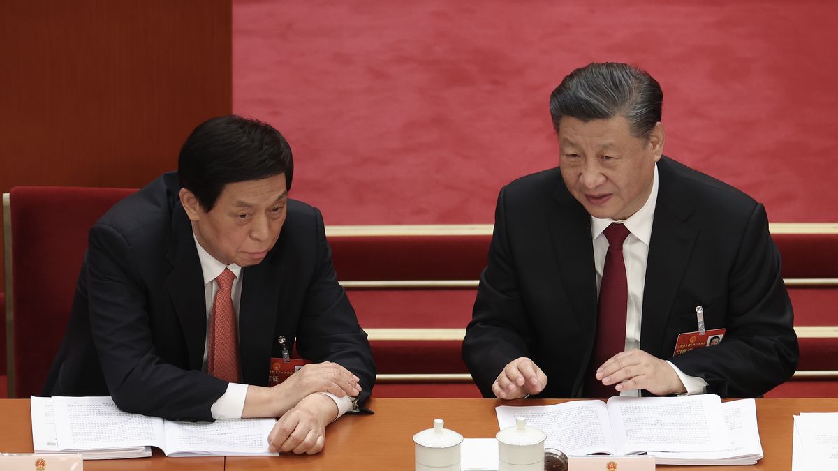 BEIJING, CHINA - MARCH 05:  Chinese President Xi Jinping (R) speaks with Li Zhanshu (L) of National People's Congress (NPC) during the opening of the first session of the 14th National People's Congress at The Great Hall of People on March 5, 2023 in Beijing, China. China's annual political gathering known as the Two Sessions will convene leaders and lawmakers to set the government's agenda for domestic economic and social development for the year. (Photo by Lintao Zhang/Getty Images)