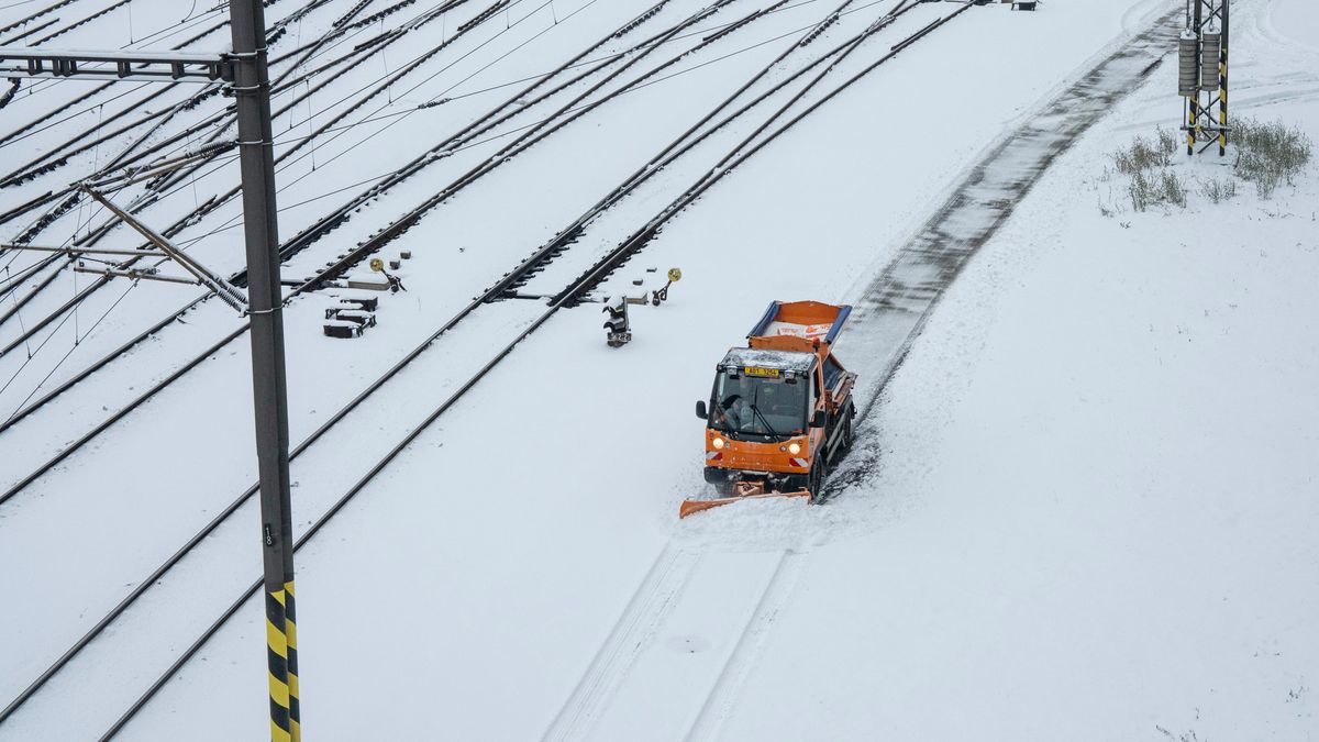 A snowplow clears a path beside snow-covered rail tracks outside Prague Main Railway Station in Prague, Czech Republic, on Friday, Jan. 9, 2026. A wave of Arctic air blanketed Europe with frigid weather and intense snowfall, snarling travel and triggering power outages in some areas. Photographer: Milan Jaros/Bloomberg via Getty Images