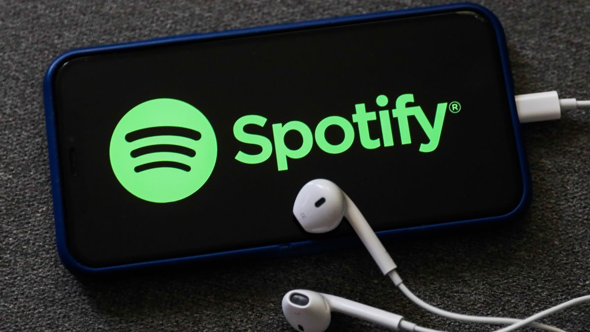 Spotify logo displayed on a phone screen and headphones are seen in this illustration photo taken in Poland on October 18, 2020.  (Photo Illustration by Jakub Porzycki/NurPhoto via Getty Images)