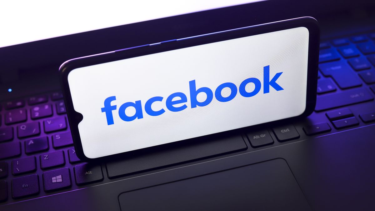 The Facebook logo appears on the screen of a smartphone that rests on top of a laptop keyboard in Reno, United States, on November 28, 2024. (Photo by Jaque Silva/NurPhoto via Getty Images)