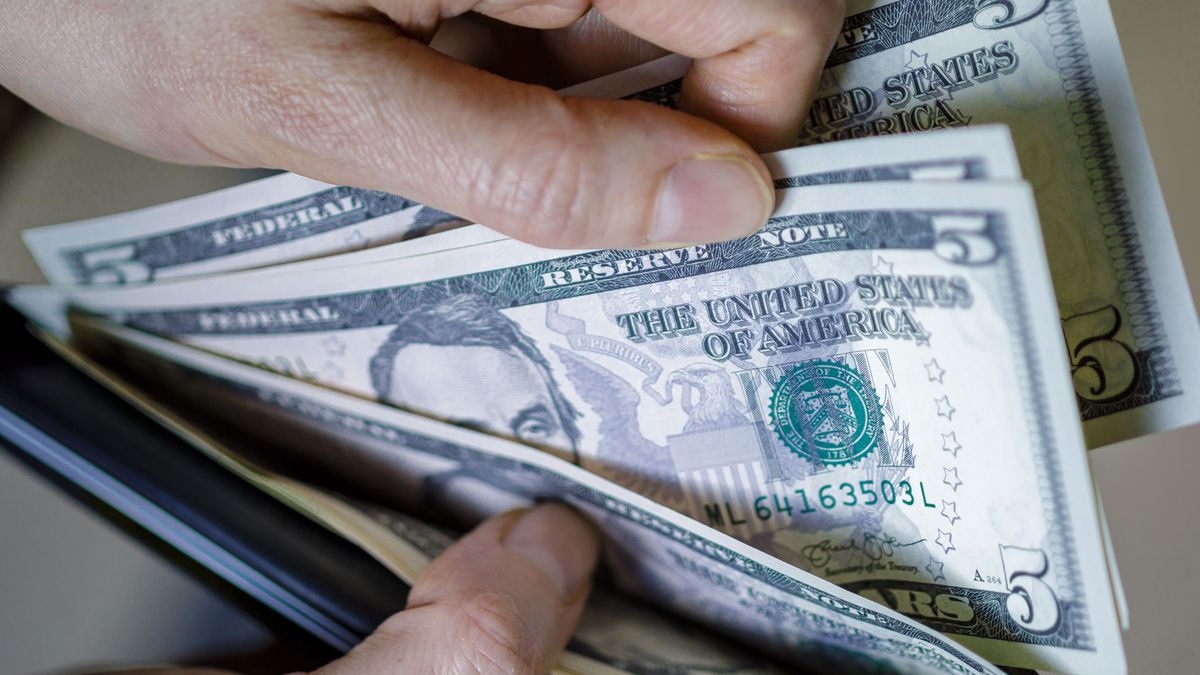 BERLIN, GERMANY - FEBRUARY 17: Symbolic photo: Dollar banknotes are counted in a wallet on February 17, 2020 in Berlin, Germany. (Photo by Thomas Trutschel/Photothek via Getty Images)