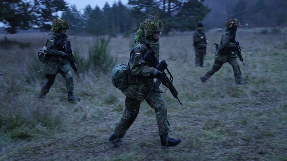 PRENZLAU, GERMANY - NOVEMBER 29: New army (Heer) recruits of the Bundeswehr, Germany's armed forces, drill a tactical manoeuvre during basic training on November 29, 2022 near Prenzlau, Germany. German Chancellor Olaf Scholz, following Russia's invasion of Ukraine, pledged to create a special fund of EUR 100 billion to invest in Germany's armed forces, which will go to both high tickets investments like modern attack aircraft and transport helicopters but also into improved preparedness of existing equipment.  (Photo by Sean Gallup/Getty Images)