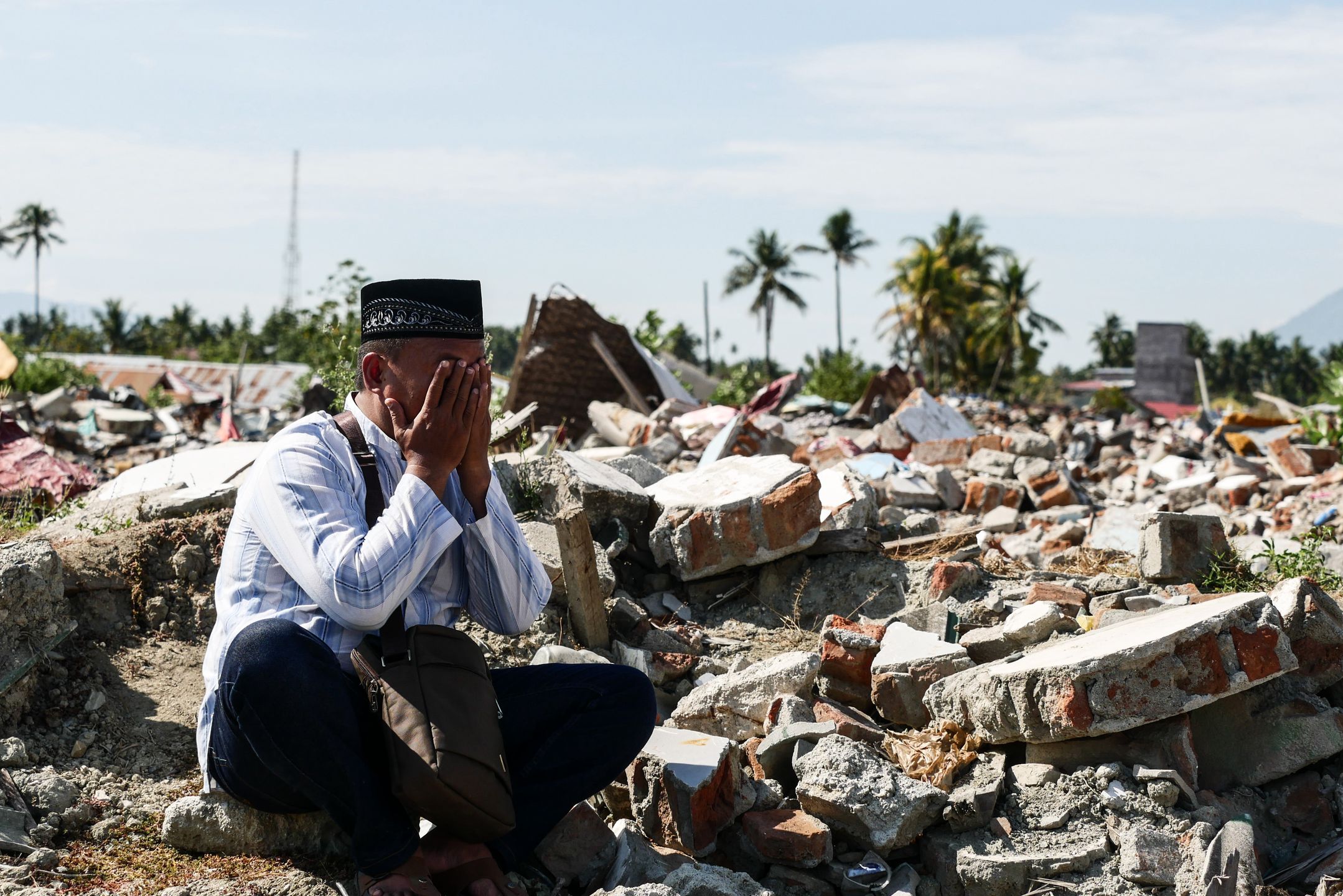 PALU, INDONESIA - SEPTEMBER 28: A man prays on the ruins where the liquefaction hit the city a year ago at Balaroa in Palu, Central Sulawesi, Indonesia on September 28, 2019. A year ago on September 28 remembered as the day when 4,340 people were killed after 7.5 SR earthquake, tsunami, and liquefaction hit Palu and Donggala. (Photo by Anton Raharjo/Anadolu Agency via Getty Images)