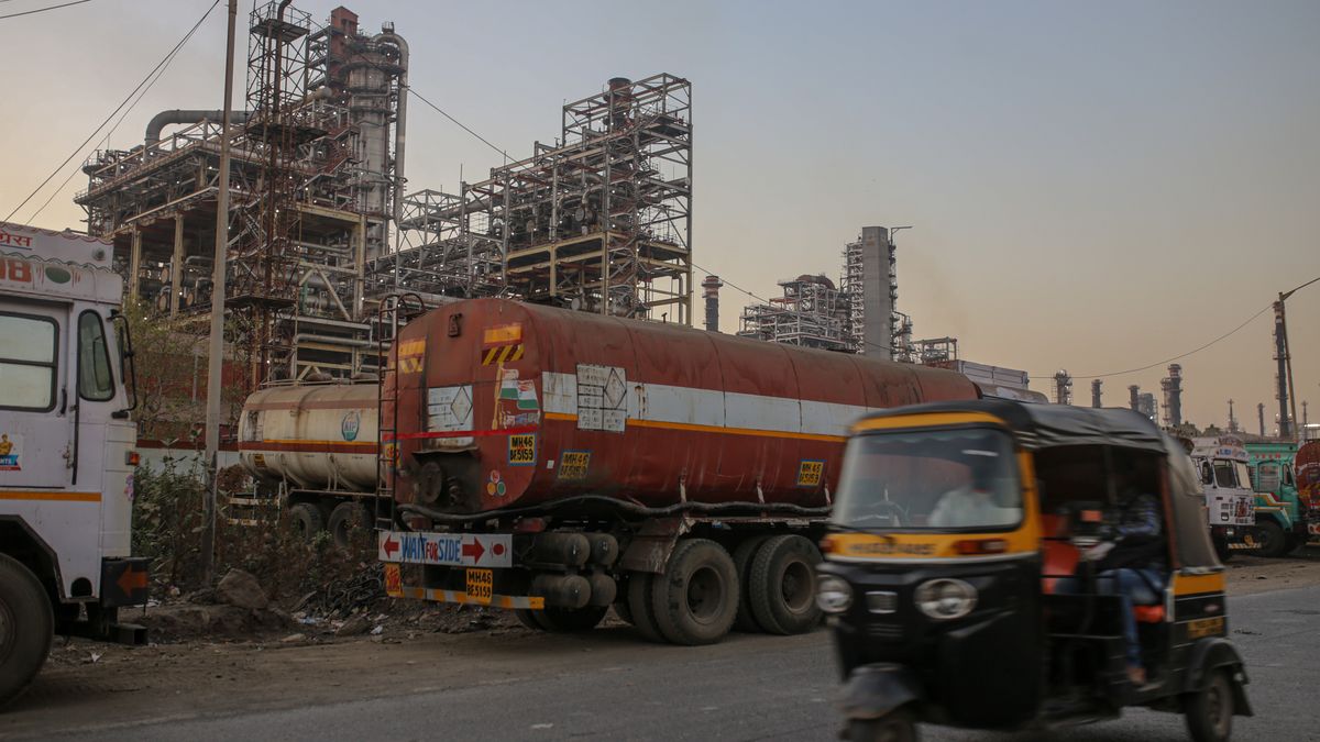 An auto-rickshaw drives past an oil refinery, operated by Bharat Petroleum Corp. Ltd., in Mumbai, India, on Saturday, Dec. 10, 2022. A senior official at India's oil ministry told reporters this month India has been buying oil from about 30 countries, and will continue to buy from anywhere including Russia beyond January. Photographer: Dhiraj Singh/Bloomberg via Getty Images