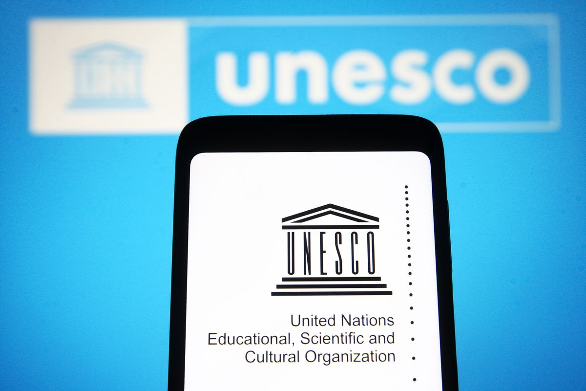 UKRAINE - 2022/01/15: In this photo illustration, UNESCO (United Nations Educational, Scientific and Cultural Organization) logo is seen on a smartphone screen and in the background. (Photo Illustration by Pavlo Gonchar/SOPA Images/LightRocket via Getty Images)