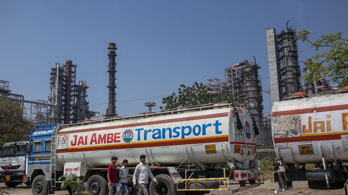 People walk by an oil refinery operated by Bharat Petroleum Corp. Ltd., in Mumbai, India, on Tuesday, April 4, 2023. A surprise cut in oil production from OPEC+ is now setting the stage for other producers to vie for markets in Asia. Photographer: Dhiraj Singh/Bloomberg via Getty Images