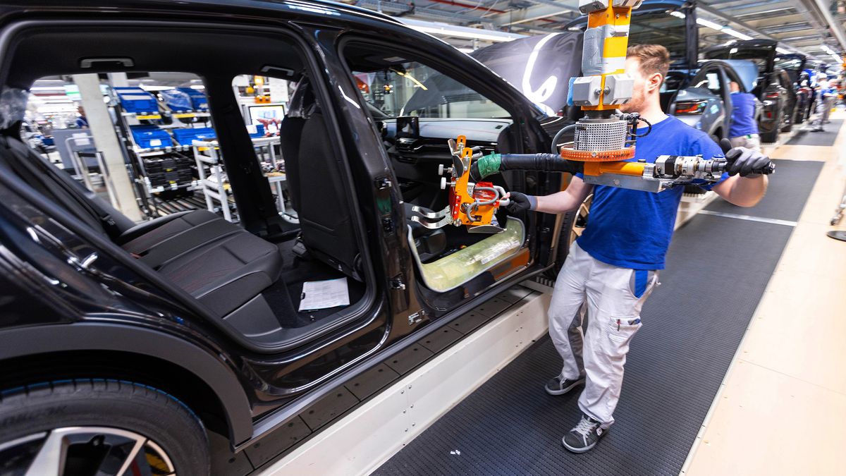 An employees fixes the seats of a Volkswagen AG (VW) ID.5 electric sports utility vehicle (eSUV) on the assembly line at the automaker's electric automobile plant in Zwickau, Germany, on Tuesday, April 26, 2022. The Zwickau assembly lines are the centerpiece of a plan by VW, the world's biggest automaker, to manufacture as many as 330,000 cars annually. Photographer: Krisztian Bocsi/Bloomberg via Getty Images