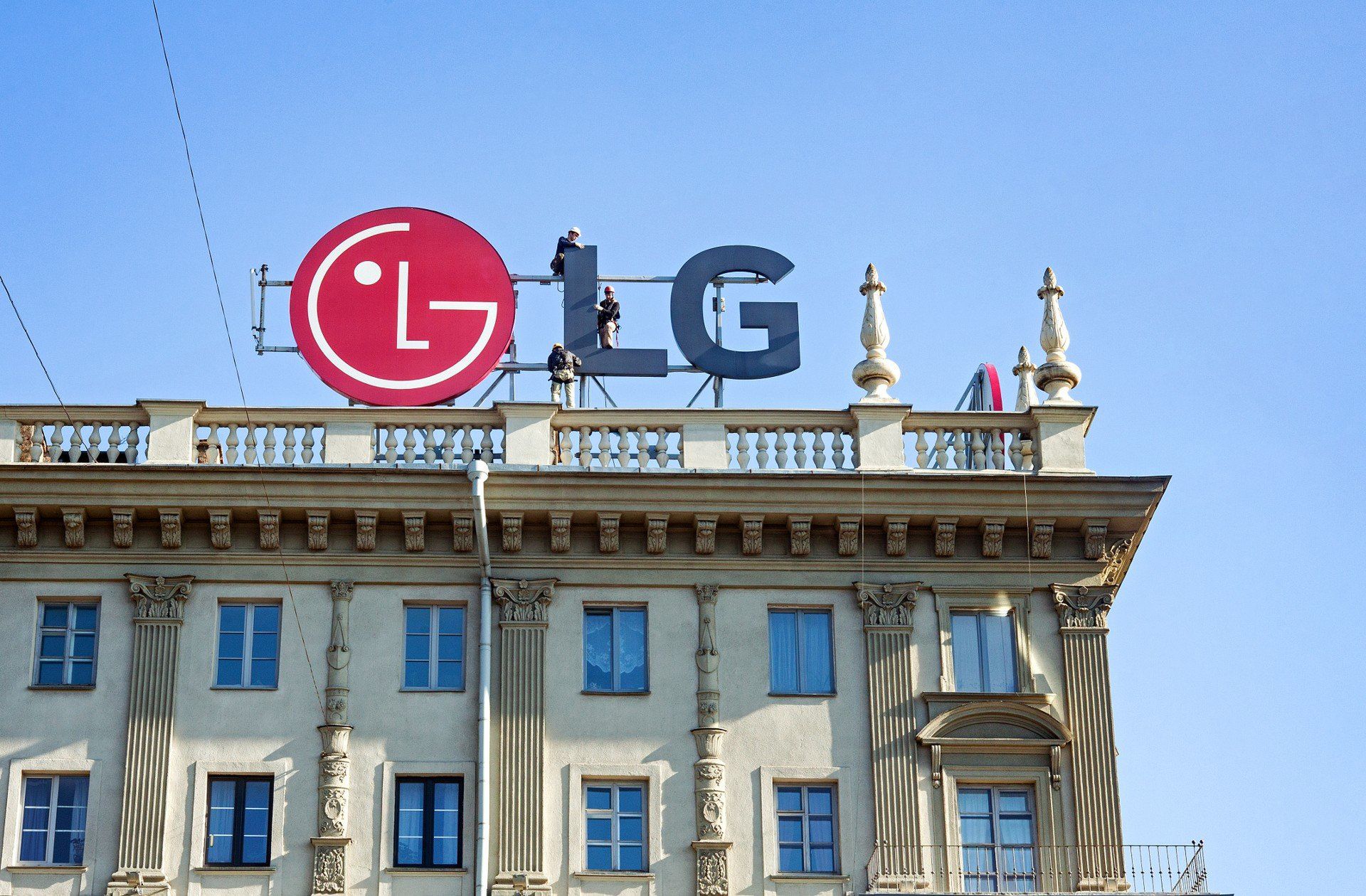 Minsk, Belarus, April 4, 2018: Workers mount LG advertising on the roof of the building