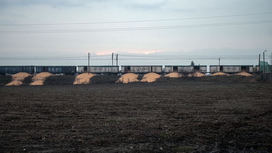 BYDGOSZCZ, POLAND - FEBRUARY 25: Piles of corn lying on the ground near train cars in the village of Kotomierz, Kuyavian-Pomeranian region, Poland on February 25, 2024. Eight wagons of a freight train containing corn, coming from Ukraine according to Kyiv, were opened and their contents dumped on a railway track in Poland. (Photo by Stringer/Anadolu via Getty Images)