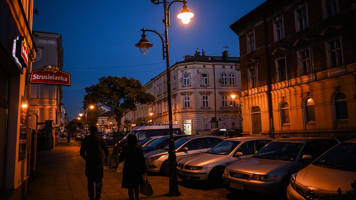 TARNOW, POLAND - OCTOBER 31 : People walk on a pedestrian street with street lamps at the old town on October 31, 2022 in Tarnow, Poland. With winter arriving in the following months and the increase of energy prices due to the Russian war on Ukraine, city authorities of the southern Polish city, Tarnow, have decided to replace more than 700 Old bulbs from the street lamps with LED ones. City authorities estimate that the installation of modern LED lighting will save about 150 MWh per year. It was also observed, that several illumination points in the old town are turned off or every second light of a lamp post is turned off. (Photo by Omar Marques/Anadolu Agency via Getty Images)