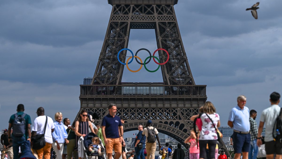 PARIS, FRANCE - JUNE 30:   
Tourists at Trocadero Plaza admire the Eiffel Tower adorned with Olympic rings, celebrating the upcoming Paris 2024 Olympic and Paralympic Games, on June 30, 2024 in Paris, France.
Paris anticipates over 11 million visitors for the XXXIII Olympic Summer Games, primarily from France, as the city prepares for the event from July 26 to August 11 (Photo by Artur Widak/NurPhoto via Getty Images)