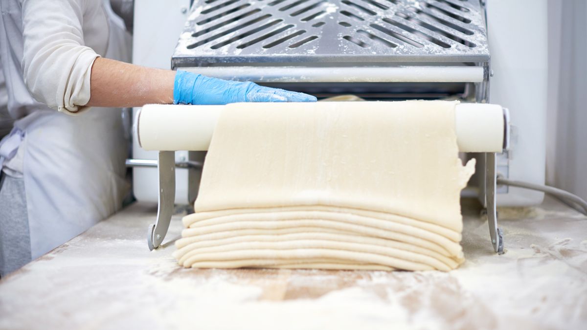 Chef  processing pasta sheet in machine at kitchen. Manufacture. Rolling dough on a dought sheeter .
Oksana Zinchenko
dough, industrial, food, technology, kitchen, white, gloved, sheet, hand, pizza, work, croissiant, cooking, chef, wheat, pin, pasta, professional, factory, machine, business, people, blue, hands, commercial, restaurant, cuisine, work, young