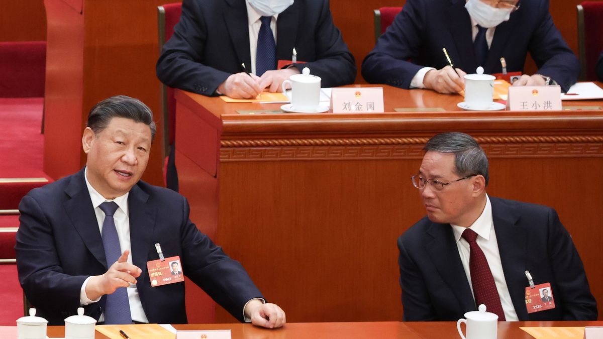 BEIJING, CHINA - MARCH 11: Chinese President Xi Jinping (L) speaks with Politburo Standing Committee member Li Qiang(R)  during the opening of the forth plenary session of the National People's Congress on March 11, 2023 in Beijing, China. China's annual political gathering, known as the Two Sessions, convenes the nation's leaders and lawmakers to set the government's agenda for domestic economic and social development for the next year.  (Photo by Lintao Zhang/Getty Images)