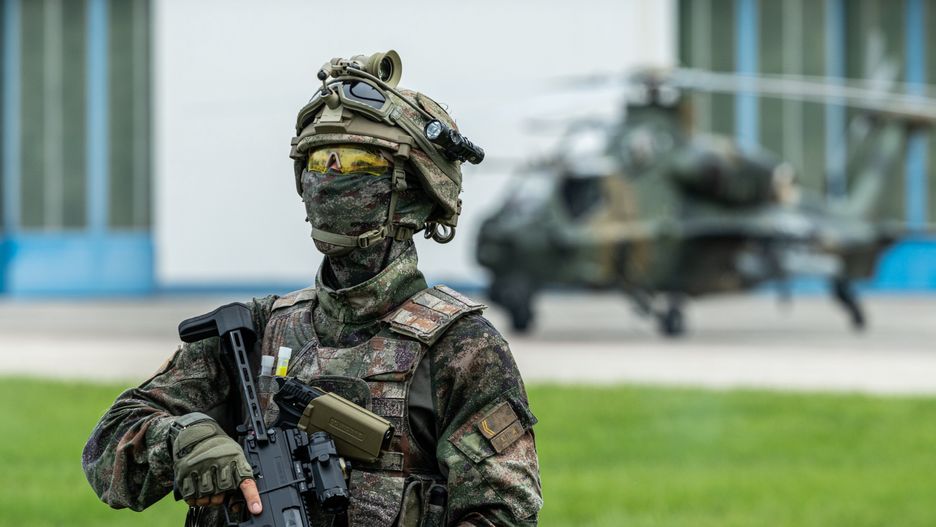HONG KONG, CHINA - JUNE 30: An armed soldier stands in front of a WZ-10 attack helicopter at Shek Kong Barracks on June 30, 2024 in Hong Kong, China. The Chinese People's Liberation Army (PLA) Garrison in Hong Kong opened its barracks to the public for two days to celebrate the 27th anniversary of Hong Kong's return to the motherland. (Photo by VCG/VCG via Getty Images)