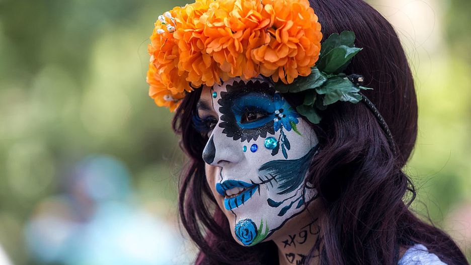 Portrait of a participant who wears a colorful costume and parades through the streets 