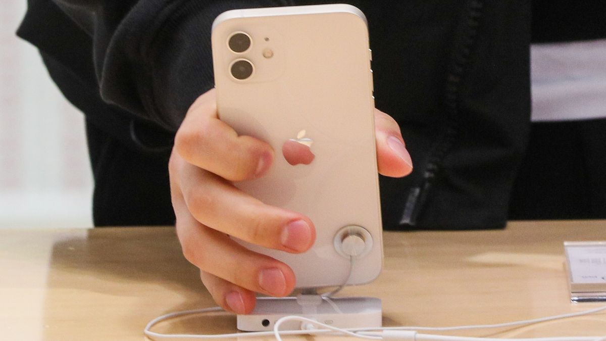 MOSCOW, RUSSIA - OCTOBER 23, 2020: A customer holds a new iPhone at a re:Store shop in Petrovka Street, as Apple has launched iPhone 12 and iPhone 12 Pro sales in Russia. Alexander Shcherbak/TASS (Photo by Alexander Shcherbak\TASS via Getty Images)