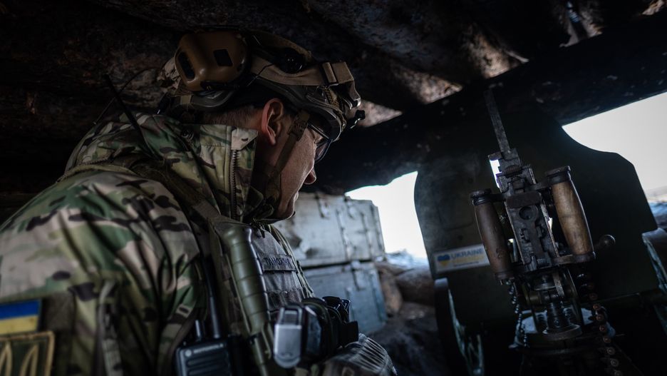 KHARKIV, UKRAINE - FEBRUARY 20: A Ukrainian soldier observes the Russian positions, located a couple of kilometers away, from a machine gun nest in the closest observation post to the Russian border in Kharkiv, Ukraine on February 20, 2023. Sometimes this observation position is attacked with a tank fire from the other side of the border. (Photo by Andres Gutierrez/Anadolu Agency via Getty Images)