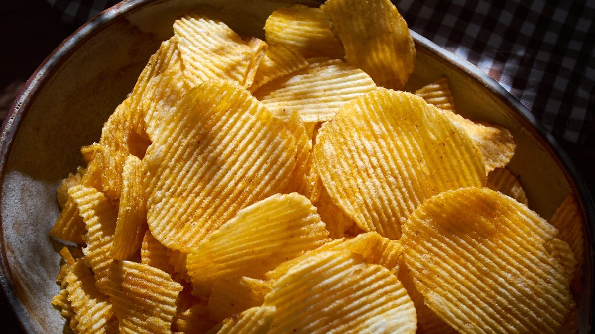 Close-up view the potato chips in the bowl
In many media shows how bad potato chips can be for your health.
Krit of Studio OMG