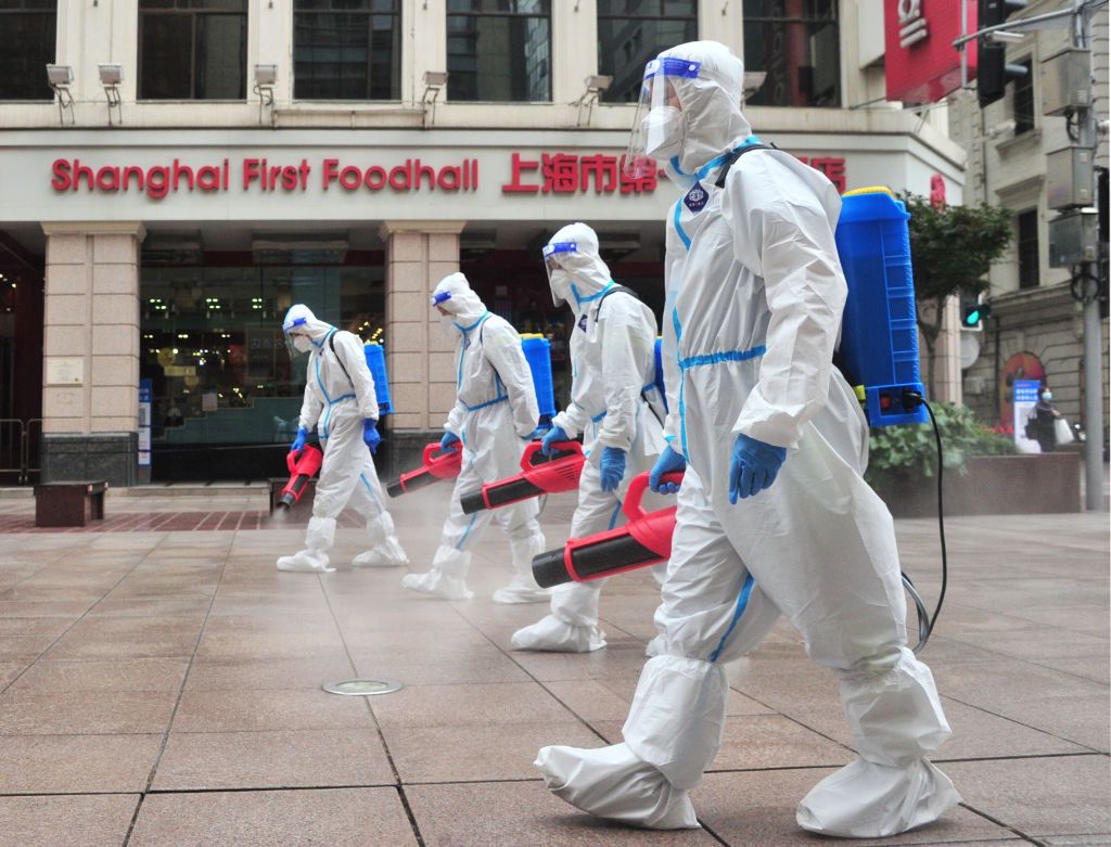 Shanghai To Resume Normal Life In 3-phaseSHANGHAI, CHINA - MAY 28: Sanitation workers wearing personal protective equipment (PPE) spray disinfectant at Nanjing Road Pedestrian Street on May 28, 2022 in Shanghai, China. Shanghai launched a three-phase plan to restore production and life to normal. (Photo by Yang Jianzheng/VCG via Getty Images)VCGchina, anti-pandemic