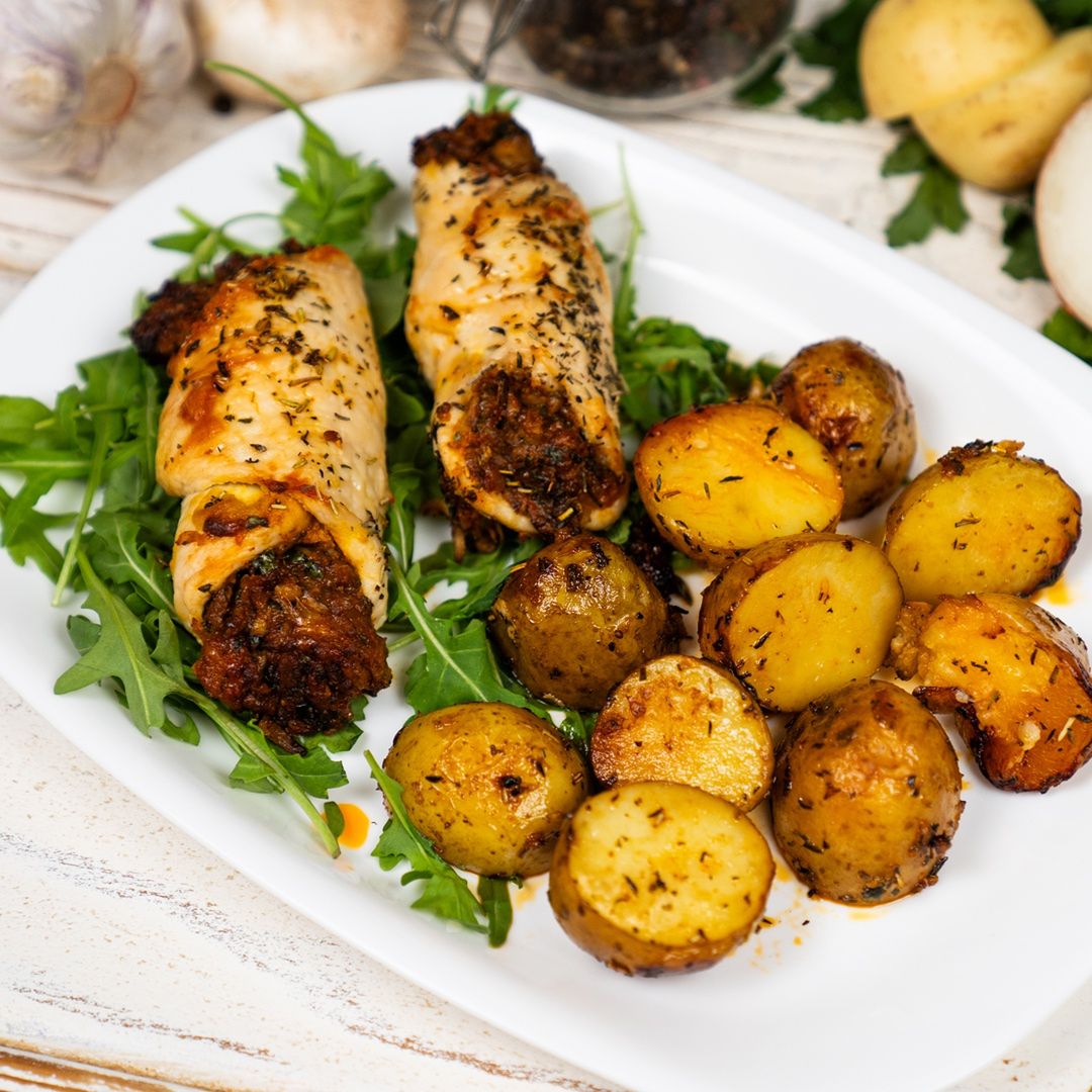 Chicken rolls baked on potatoes